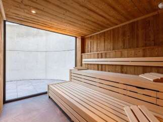 Step into relaxation with this stunning sauna, featuring warm wooden interiors and a spacious design.