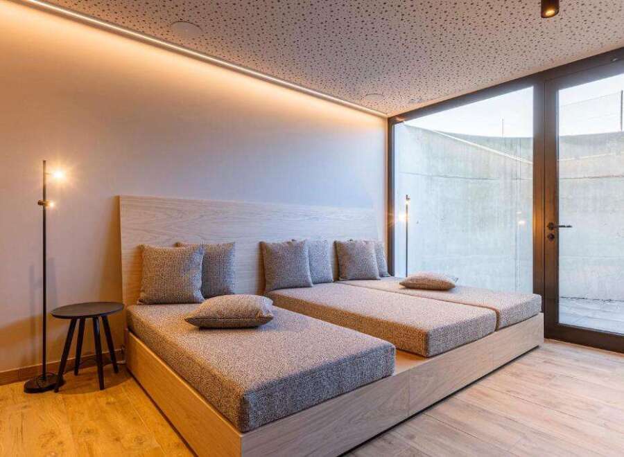 Experience ultimate relaxation in this luxurious bedroom featuring two comfortable beds and a stylish design.