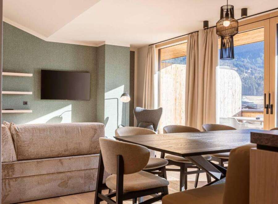 Experience luxury living in this stunning property, featuring a modern living room with a sleek TV and stylish decor.