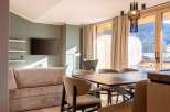 Experience luxury living in this stunning property, featuring a modern living room with a sleek TV and stylish decor.