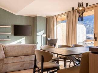 Experience luxury living in this stunning property, featuring a modern living room with a sleek TV and stylish decor.