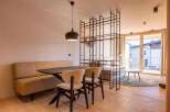Experience modern living in this stylish property, featuring a sleek dining area with a contemporary table and chairs.