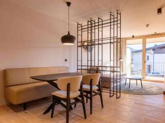 Experience modern living in this stylish property, featuring a sleek dining area with a contemporary table and chairs.