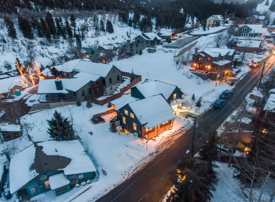 Nestled in a snowy mountainside, this charming home offers a cozy retreat with stunning views.