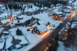 Nestled in a snowy mountainside, this charming home offers a cozy retreat with stunning views.