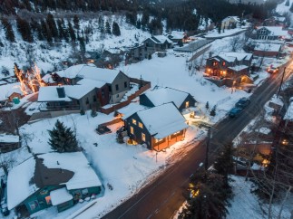 Nestled in a snowy mountainside, this charming home offers a cozy retreat with stunning views.