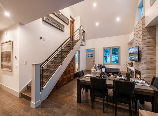 This stunning home boasts an open floor plan with hardwood floors, a modern staircase, and a cozy fireplace.