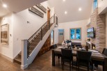 This stunning home boasts an open floor plan with hardwood floors, a modern staircase, and a cozy fireplace.
