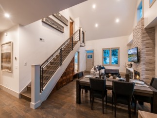 This stunning home boasts an open floor plan with hardwood floors, a modern staircase, and a cozy fireplace.