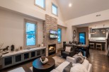 This stunning vacation rental boasts an open-concept living area with a cozy fireplace, perfect for relaxing after a day of adventure.