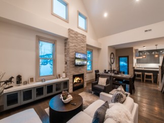 This stunning vacation rental boasts an open-concept living area with a cozy fireplace, perfect for relaxing after a day of adventure.