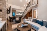 Stunning mountain home with open-concept living, featuring a cozy fireplace and expansive windows.