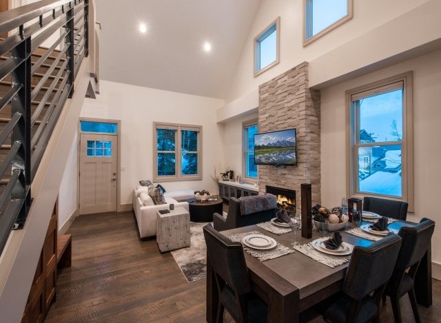 This stunning property boasts an open-concept living area with vaulted ceilings and large windows offering breathtaking views.