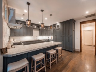 This stunning kitchen boasts a spacious island with seating, perfect for casual dining and entertaining.