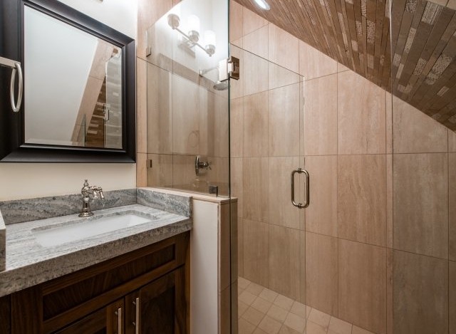 This luxurious bathroom boasts a spacious shower with glass enclosure and elegant tile work.