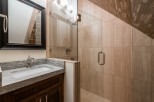 This luxurious bathroom boasts a spacious shower with glass enclosure and elegant tile work.