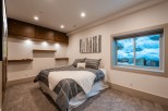 Cozy basement bedroom with a stunning view of a snow-covered landscape outside the window.