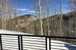 Stunning mountain views from a deck with a modern metal railing.