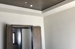 This stunning property boasts a beautiful coffered ceiling with dark wood beams, adding a touch of elegance to the space.