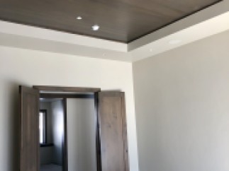 This stunning property boasts a beautiful coffered ceiling with dark wood beams, adding a touch of elegance to the space.