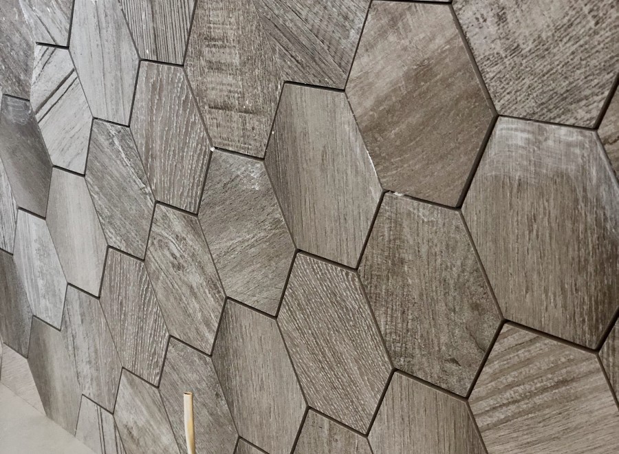 Stunning hexagon wood-look tiles create a unique and modern wall design.