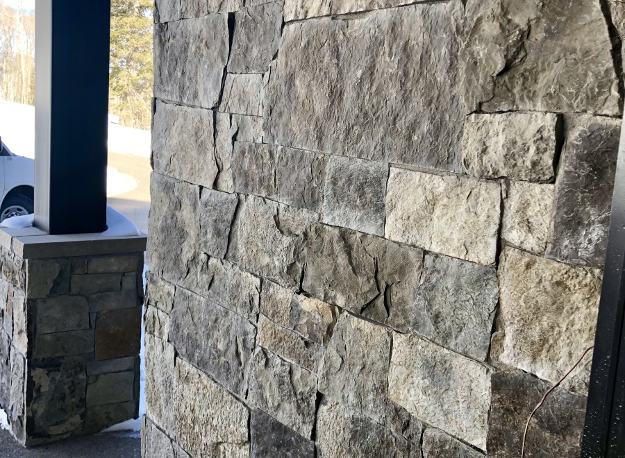 This stunning property boasts a rustic-chic exterior, featuring a beautiful blend of natural stone and wood.