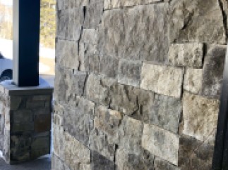 This stunning property boasts a rustic-chic exterior, featuring a beautiful blend of natural stone and wood.