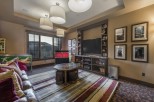 This luxurious family room boasts a large window showcasing stunning mountain views, creating a bright and inviting atmosphere.