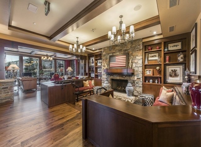 This luxurious lodge boasts a stunning stone fireplace, custom built-ins, and rich hardwood floors.