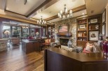 This luxurious lodge boasts a stunning stone fireplace, custom built-ins, and rich hardwood floors.