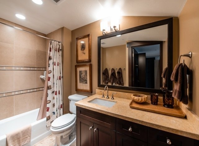 This luxurious bathroom boasts a spacious layout with a large mirror reflecting the elegant design.