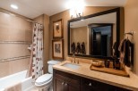 This luxurious bathroom boasts a spacious layout with a large mirror reflecting the elegant design.