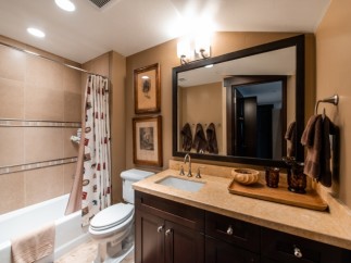 This luxurious bathroom boasts a spacious layout with a large mirror reflecting the elegant design.