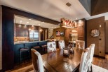 This stunning property boasts a spacious dining area with a rustic-chic design, featuring a large wooden table and cowhide chairs.