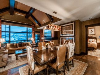 This luxurious mountain condo boasts stunning views, a spacious open floor plan, and a gourmet kitchen.