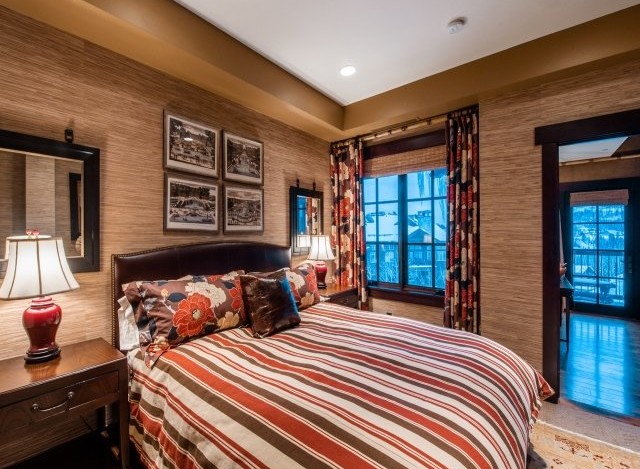 Luxurious mountain getaway boasting a king-size bed with designer bedding and stunning views.