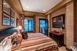 Luxurious mountain getaway boasting a king-size bed with a stunning view.