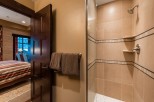 This luxurious bathroom boasts a spacious shower with elegant tile work and modern fixtures.