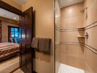 This luxurious bathroom boasts a spacious shower with elegant tile work and modern fixtures.