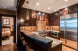 This luxurious kitchen boasts stunning dark wood cabinetry, granite countertops, and high-end stainless steel appliances.