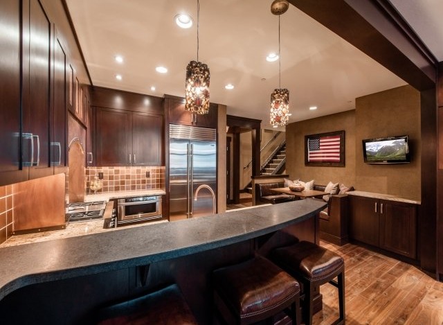 This stunning kitchen boasts a custom-designed island with leather bar stools, perfect for entertaining.