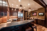 This stunning kitchen boasts a custom-designed island with leather bar stools, perfect for entertaining.