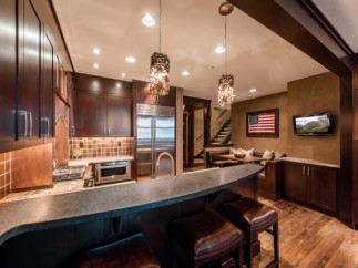 This stunning kitchen boasts a custom-designed island with leather bar stools, perfect for entertaining.