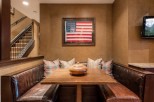 Cozy built-in banquette with leather seating and a rustic wooden table, perfect for intimate gatherings.