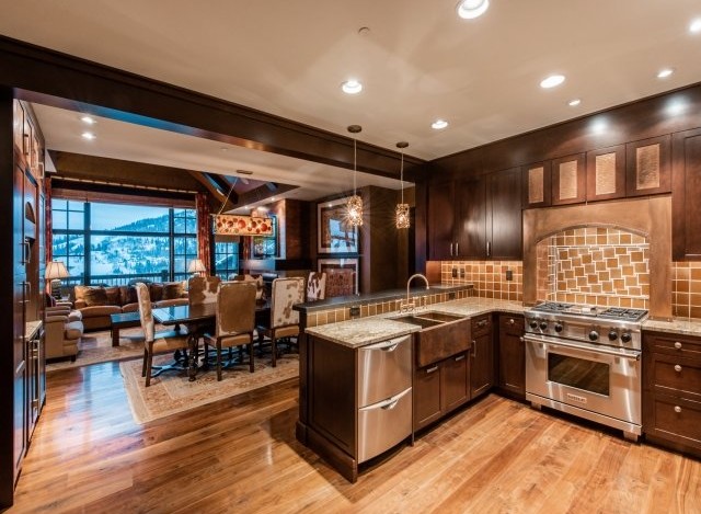 This luxurious condo boasts a gourmet kitchen with top-of-the-line appliances and a stunning granite island, perfect for entertaining.