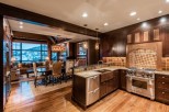 This luxurious condo boasts a gourmet kitchen with top-of-the-line appliances and a stunning granite island, perfect for entertaining.