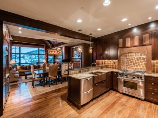 This luxurious condo boasts a gourmet kitchen with top-of-the-line appliances and a stunning granite island, perfect for entertaining.