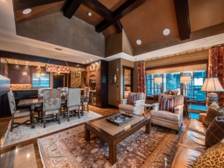 This luxurious living space boasts a spacious open floor plan, seamlessly connecting the dining area and living room.
