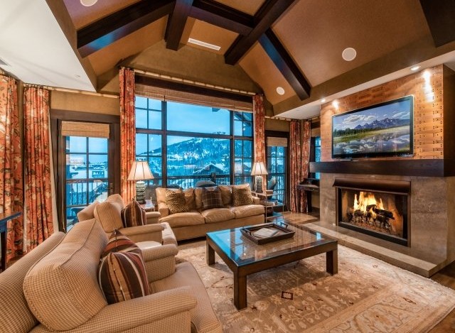Luxurious mountain lodge with vaulted ceilings and expansive windows offering breathtaking views.
