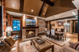 Luxurious mountain condo with a spacious open floor plan, featuring a cozy fireplace, elegant dining area, and stunning views.